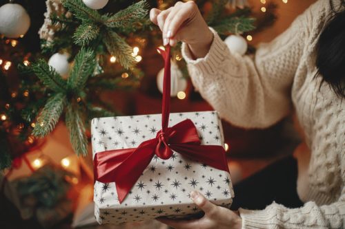 woman unwrapping christmas present