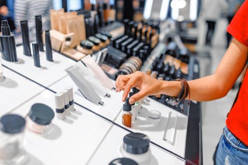 woman chooses cosmetics and make-up products in a store
