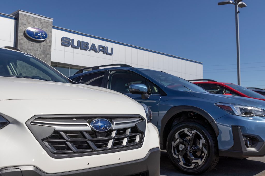 A close up of cars at a Subaru dealership