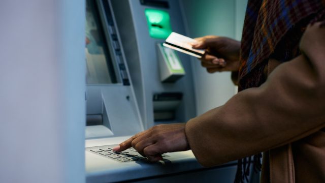 close up of woman using atm