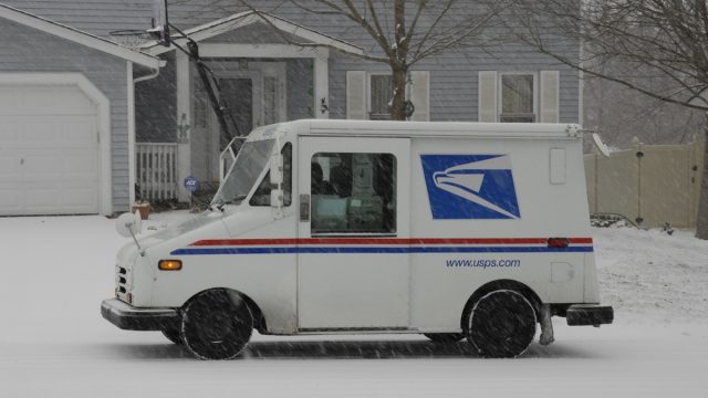 St. Peters, United States – December 23, 2008: A US postal service vehicle delivering the mail in a snowstorm in Missouri