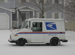 St. Peters, United States – December 23, 2008: A US postal service vehicle delivering the mail in a snowstorm in Missouri