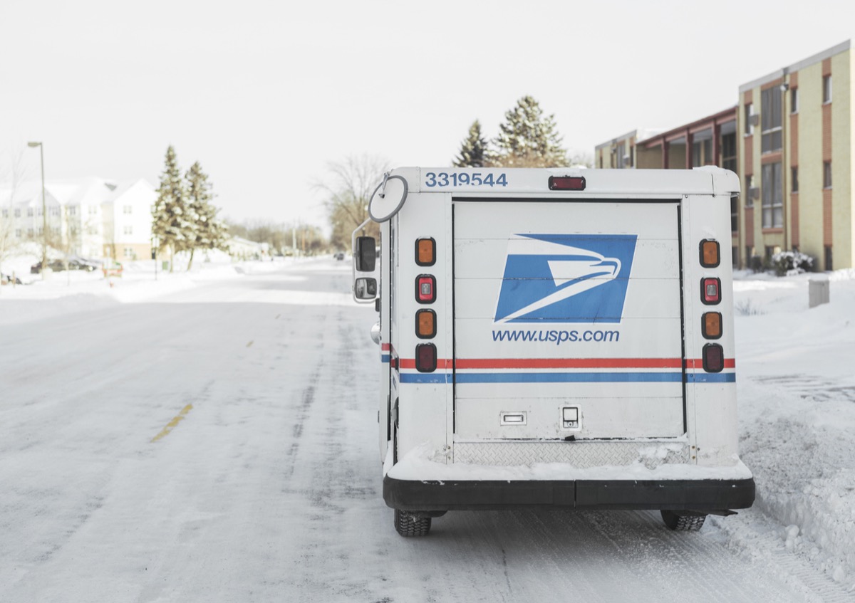 Moorhead, Minnesota, United States - January 16, 2016: USPS, United States Postal Service, van parked on suburban street during winter with lots of snow.