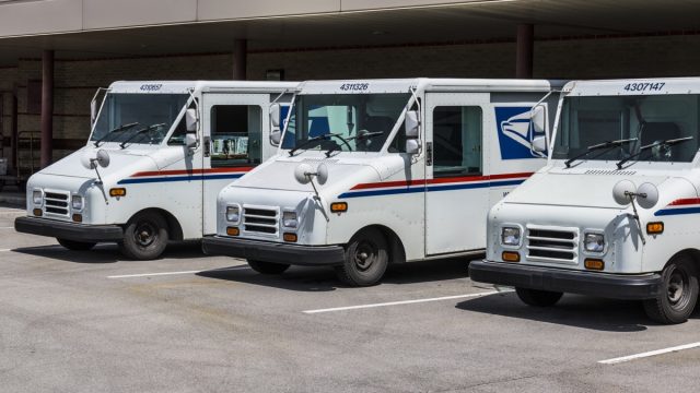 Indianapolis - Circa May 2017: USPS Post Office Mail Trucks. The USPS is Responsible for Providing Mail Delivery V