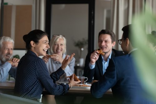 group of co-workers thinking of fun questions to ask each other during lunch
