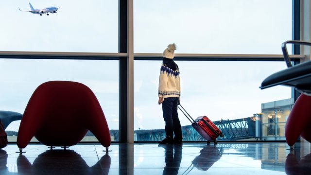 Girl waiting at the airport with suitcase