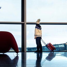 Girl waiting at the airport with suitcase