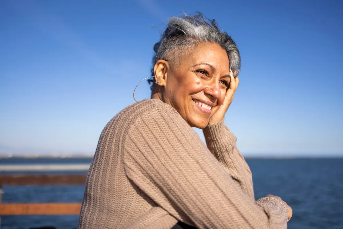 Mature, happy woman relaxing at the pier