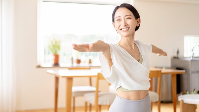 An,Asian,Middle aged,Woman,Is,Doing,Yoga,In,Her,Living