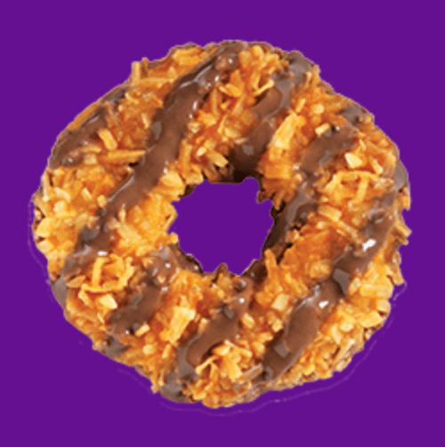 A Girl Scout Samoa cookie against a purple background