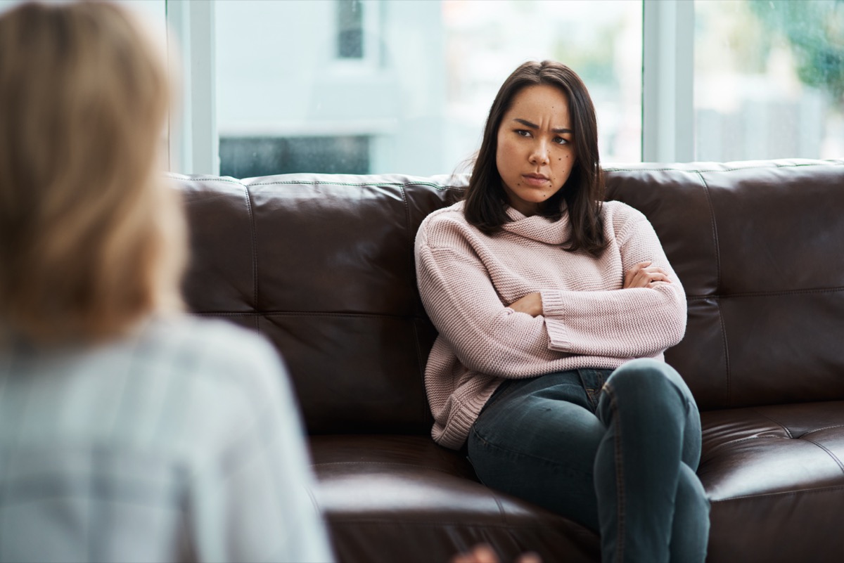 Grumpy Woman Folding Arms on Couch