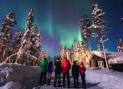 Beautiful picture of massive multicolored green vibrant Aurora Borealis, Aurora Polaris, also know as Northern Lights in the night sky over winter Lapland landscape, Norway, Scandinavia