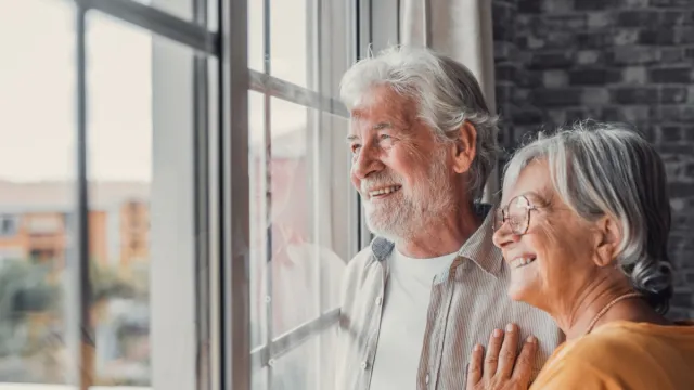 Retired Couple Looking Out Window