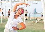 Old woman doing fitness exercises outdoors