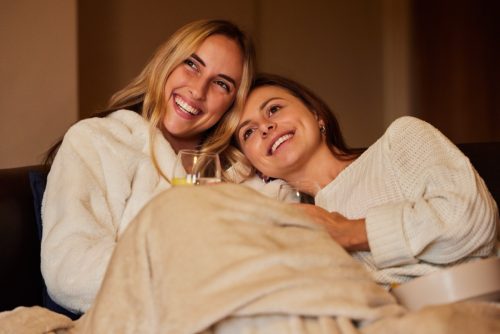 Two Women Snuggled on Couch