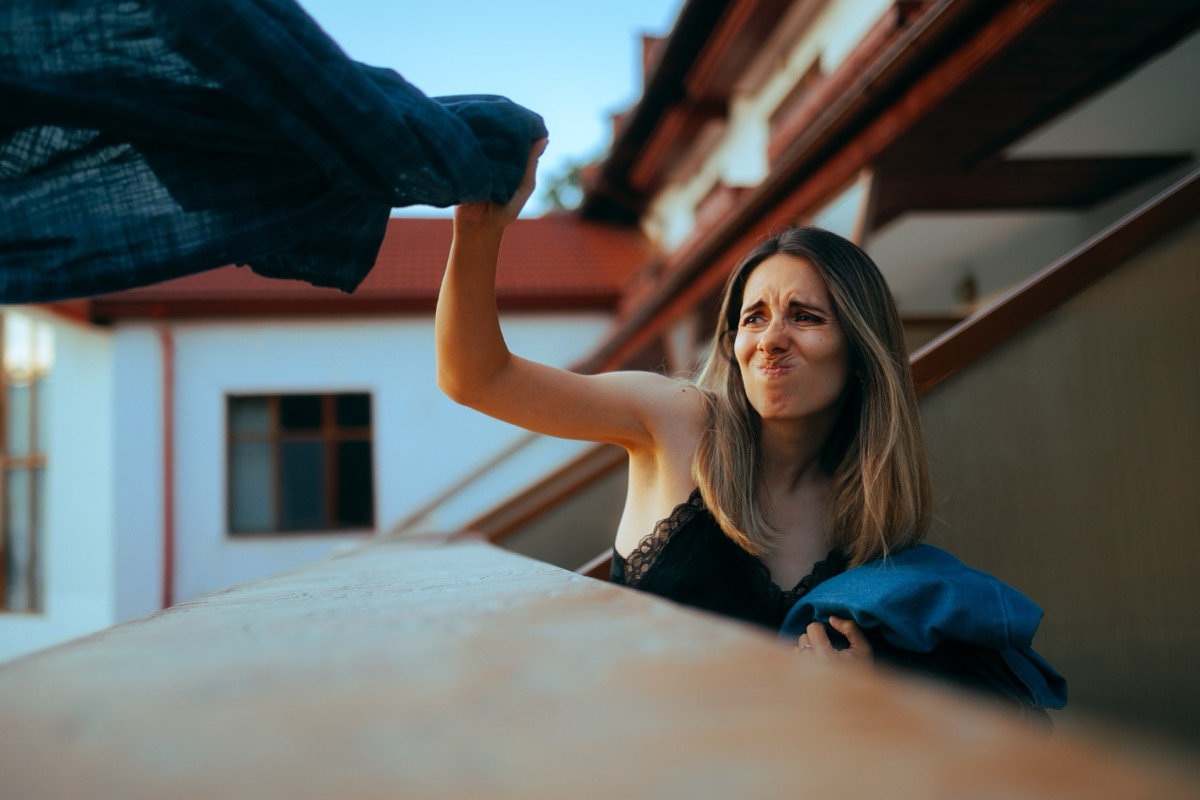 Woman Throwing Clothes Out the Window