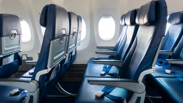Two rows of empty seats on an airplane