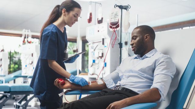 Businessman Donating Blood For People In Need In Bright Hospital