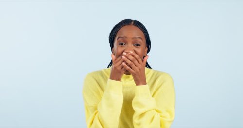 woman covering her mouth and laughing at funny names