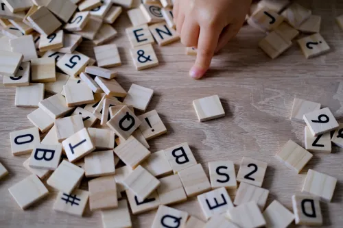 child playing with wooden alphabet blocks