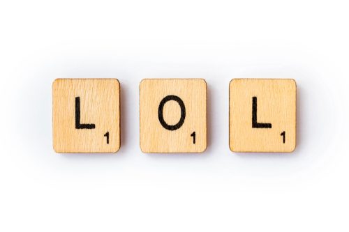 "lol" spelled out in Scrabble letters over a white background