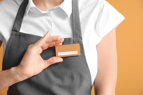 Close-up of a waitress with blank name badge
