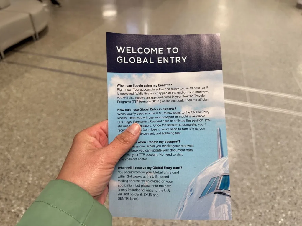 hand holding global entry welcome flyer