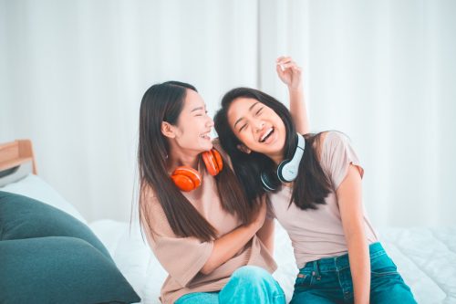 two teenage girls listening to music together
