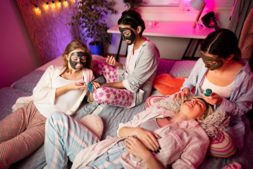 group of girl friends doing face masks before bed
