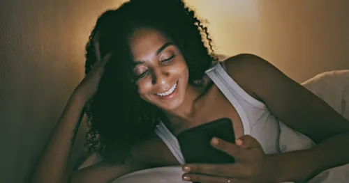 woman reading romantic goodnight messages for her on a smartphone