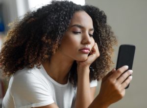 woman disappointed looking at phone