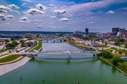 An aerial shot of the Iowa Women of Achievement Bridge across the Des Moines River in Downtown Des Moines, Iowa