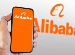 hand holding a phone with Alibaba mobile app on the screen