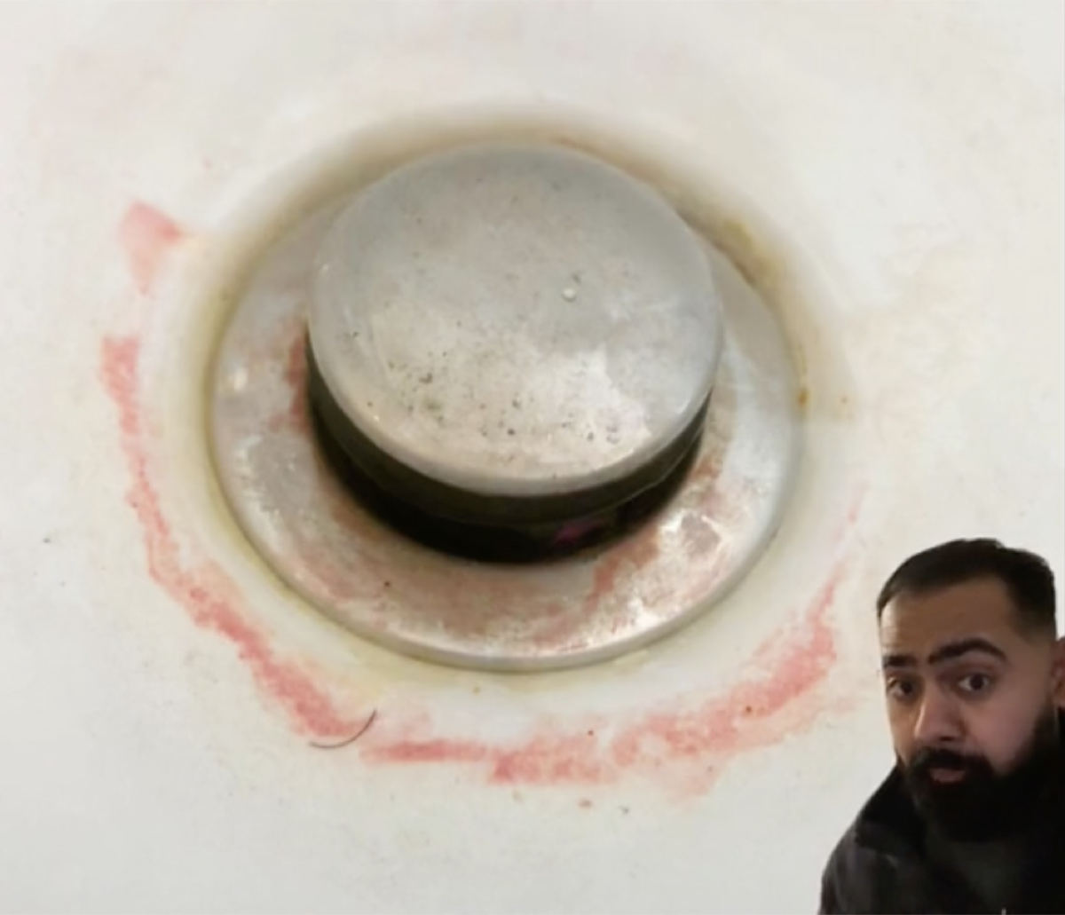 screenshot of tiktok video showing pink slime ring around shower drain