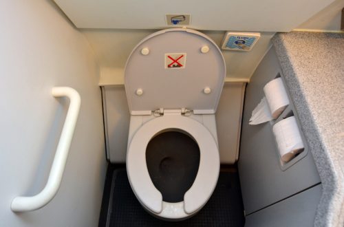 Aircraft lavatory toilets aboard a jetliner airplane.