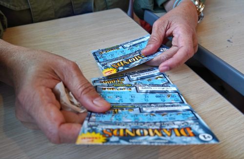 holding scratch-off lottery tickets