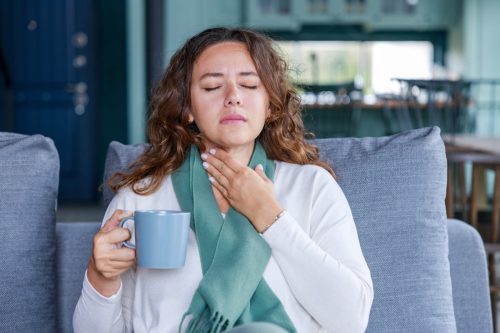 woman sick with sore throat