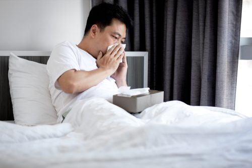 man sick in bed with congestion