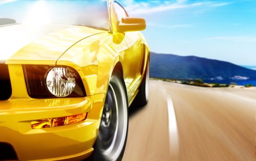Yellow sport car driving fast