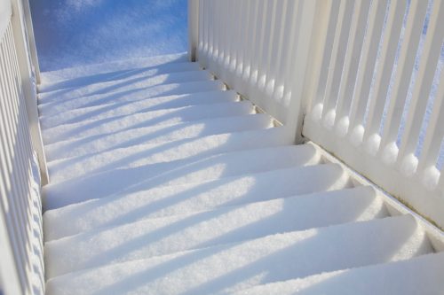 A abstract image of a set of outdoor stairs covered in snow.