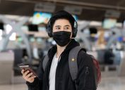traveler wearing headphones at the airport
