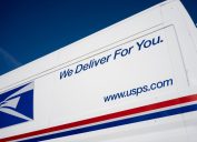 Beaverton, OR, USA - Jan 25, 2022: Closeup of the USPS logo and slogan seen on a United States Postal Service (USPS) van parked on the streets in Beaverton, Oregon.