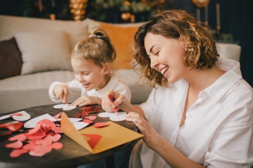 Mother and daughter making Valentine's day cards