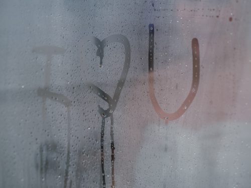 Love message written on glass shower screen