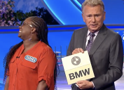 pat sajak holding bmw prize on wheel of fortune