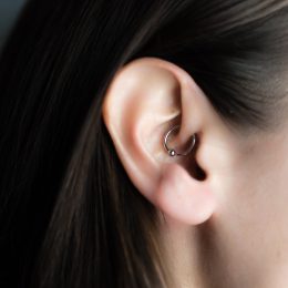 Brunette woman with daith piercing in her ear