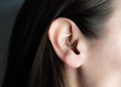 Brunette woman with daith piercing in her ear