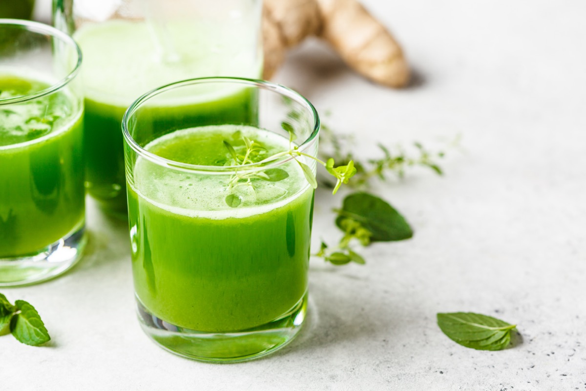 Green detox juice with ginger and mint in glasses and jars. Vegan detox concept.