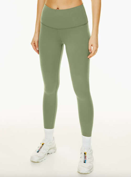 Below-waist show of model wearing sage green leggings
