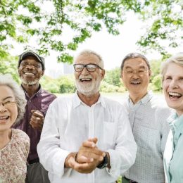 Group of mature friends smiling outside